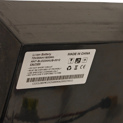 Battery label on a black surface with text and symbols